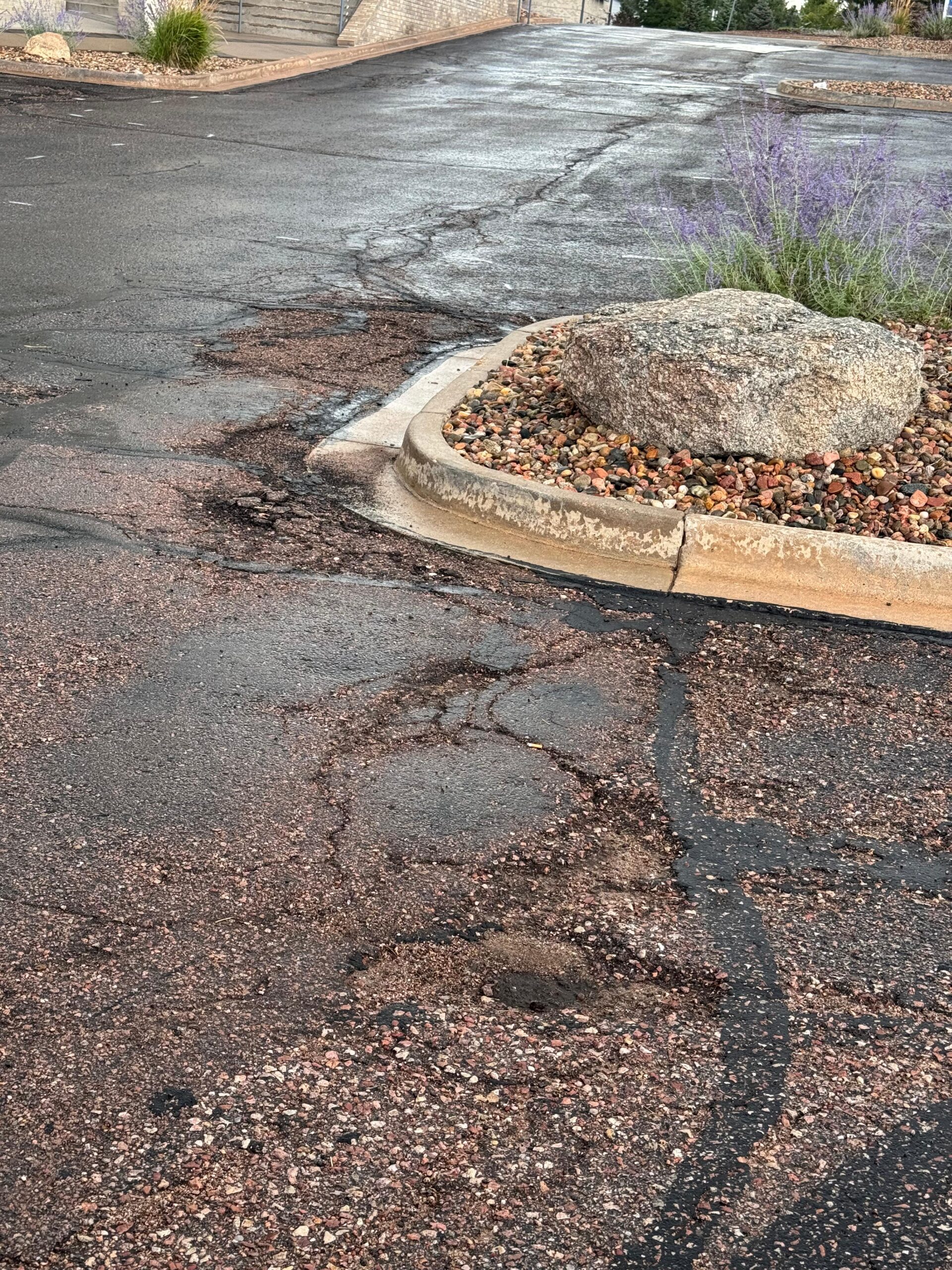 Hot-pour rubberized crack sealant lines on a commercial asphalt parking lot