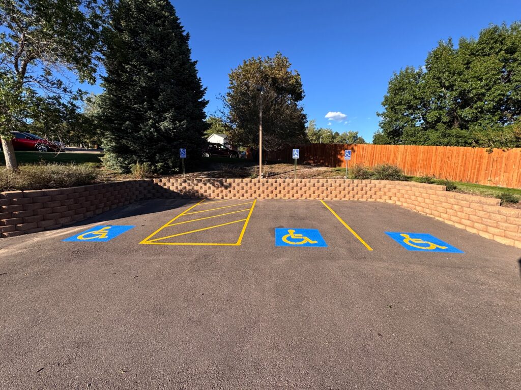 Van-accessible ADA parking stalls with a hatched access aisle and blue handicap symbols